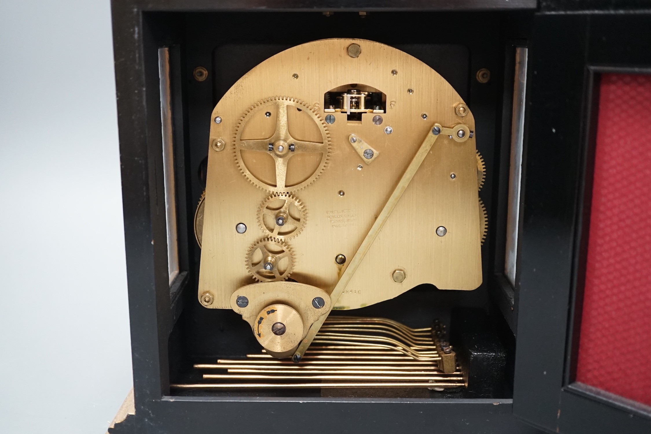 A F.W. Elliott japanned mantel clock, with chiming mechanism, 32 cms high